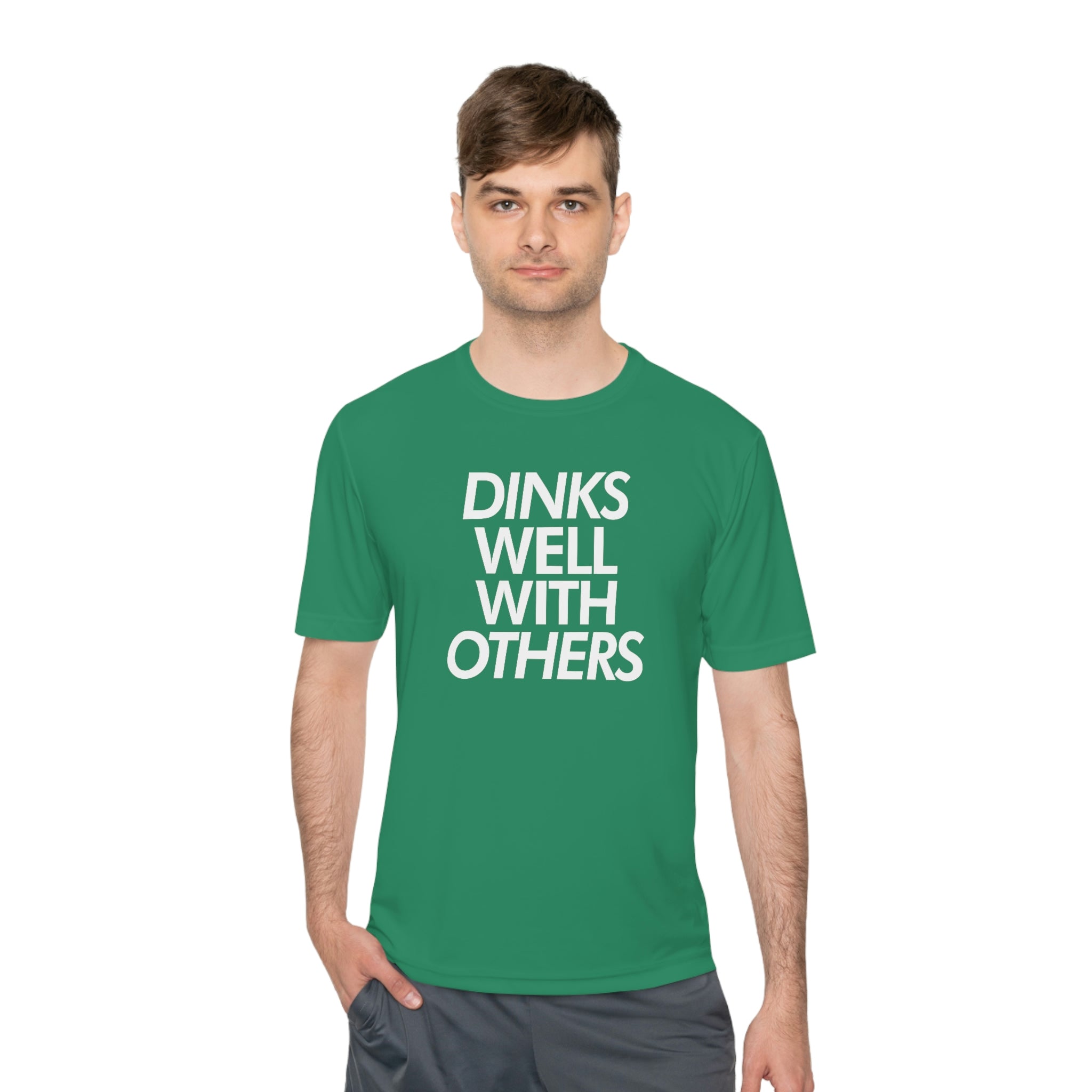 man wearing kelly green dinks well with others athletic performance pickleball shirt apparel front view