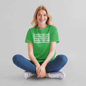 smiling woman in jeans and sneakers wearing kelly green drop & dink & drive pickleball apparel shirt front view