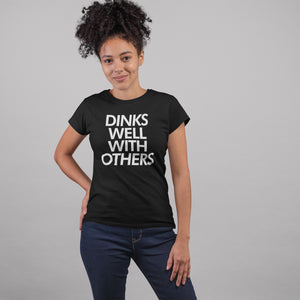 woman with curly hair wearing a black dinks well with others pickleball shirt apparel front view