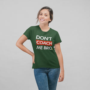 smiling woman with with ponytail wearing forest green don't coach me bro pickleball shirt apparel front view