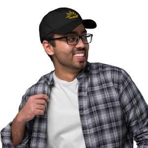 smiling man with glasses wearing black embroidered day dinker pickleball dad hat with pickleball sun pattern yellow on black