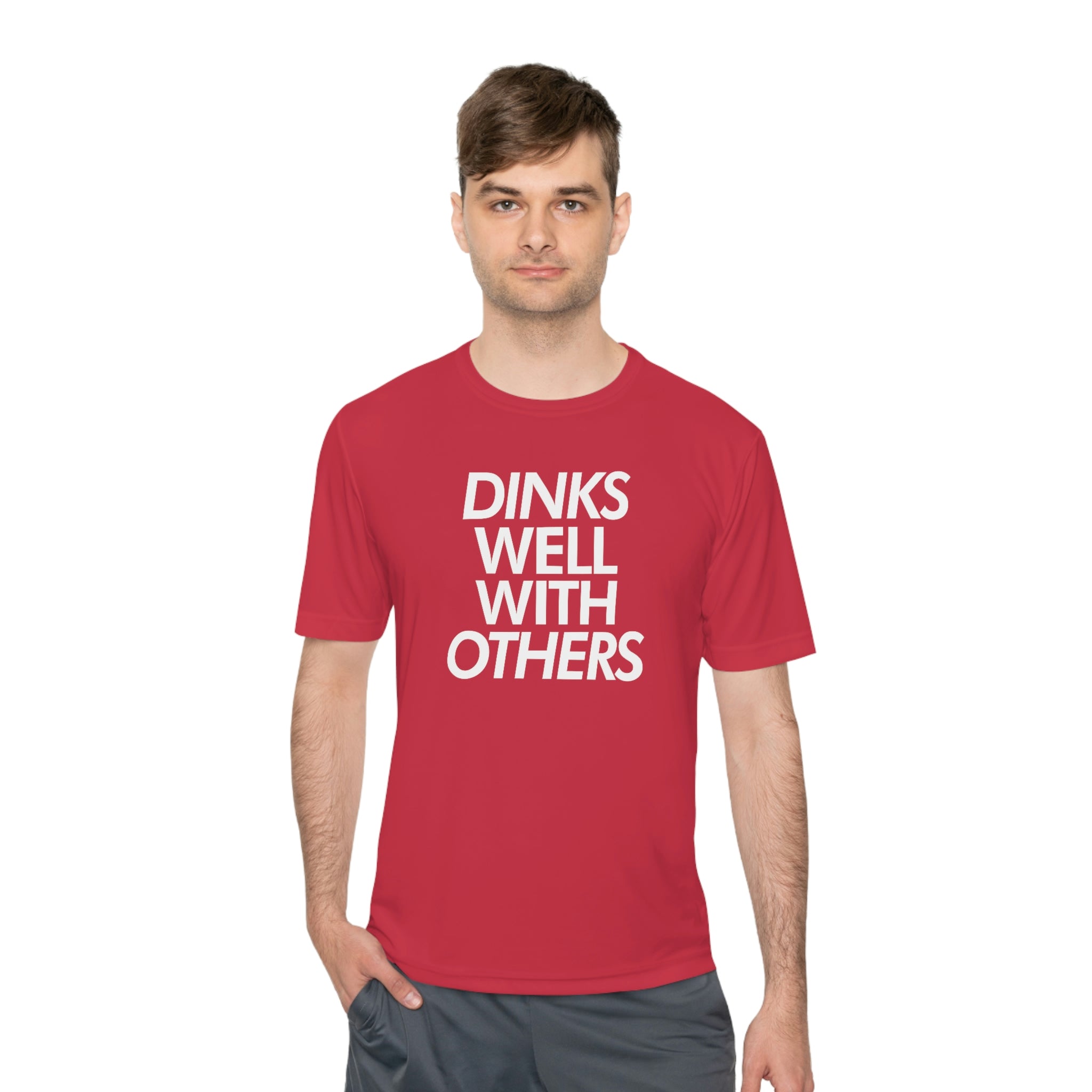 man wearing coral red dinks well with others athletic performance pickleball shirt apparel front view