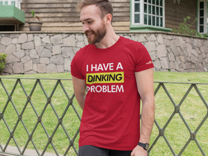 man wearing unisex red i have a dinking problem pickleball shirt apparel front view