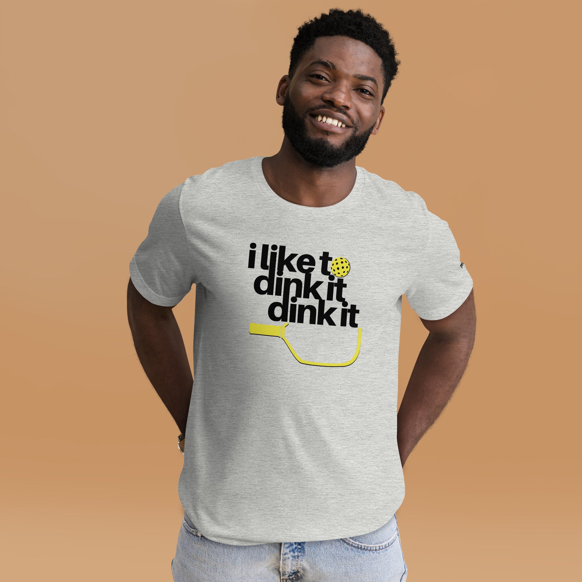 smiling man in jeans wearing heather gray i like to dink it dink it pickleball apparel athletic performance shirt front view