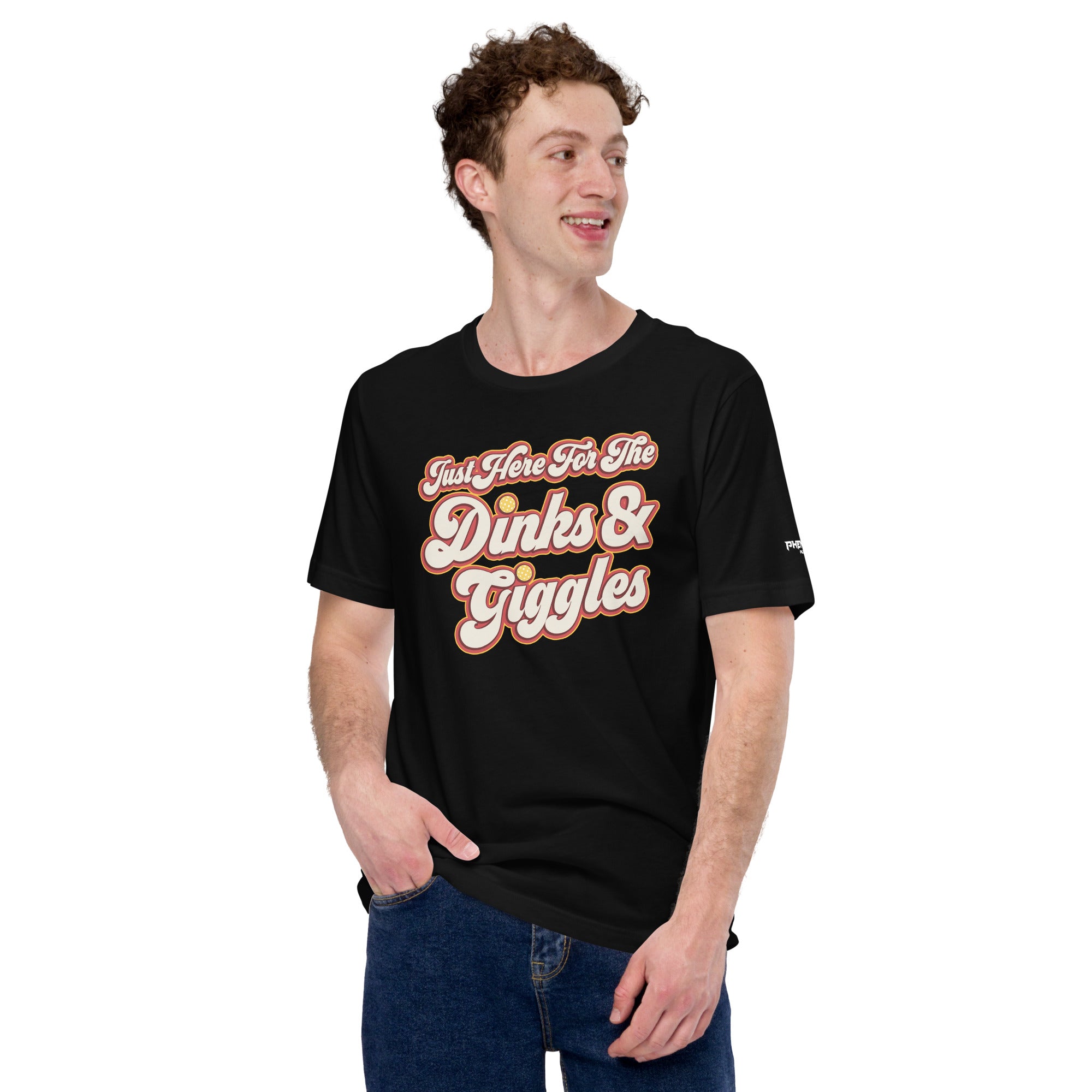 smiling man wearing black just here for the dinks and giggles pickleball shirt apparel front view