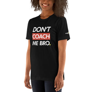 smiling woman with curly hair wearing black don't coach me bro pickleball shirt apparel left side front view