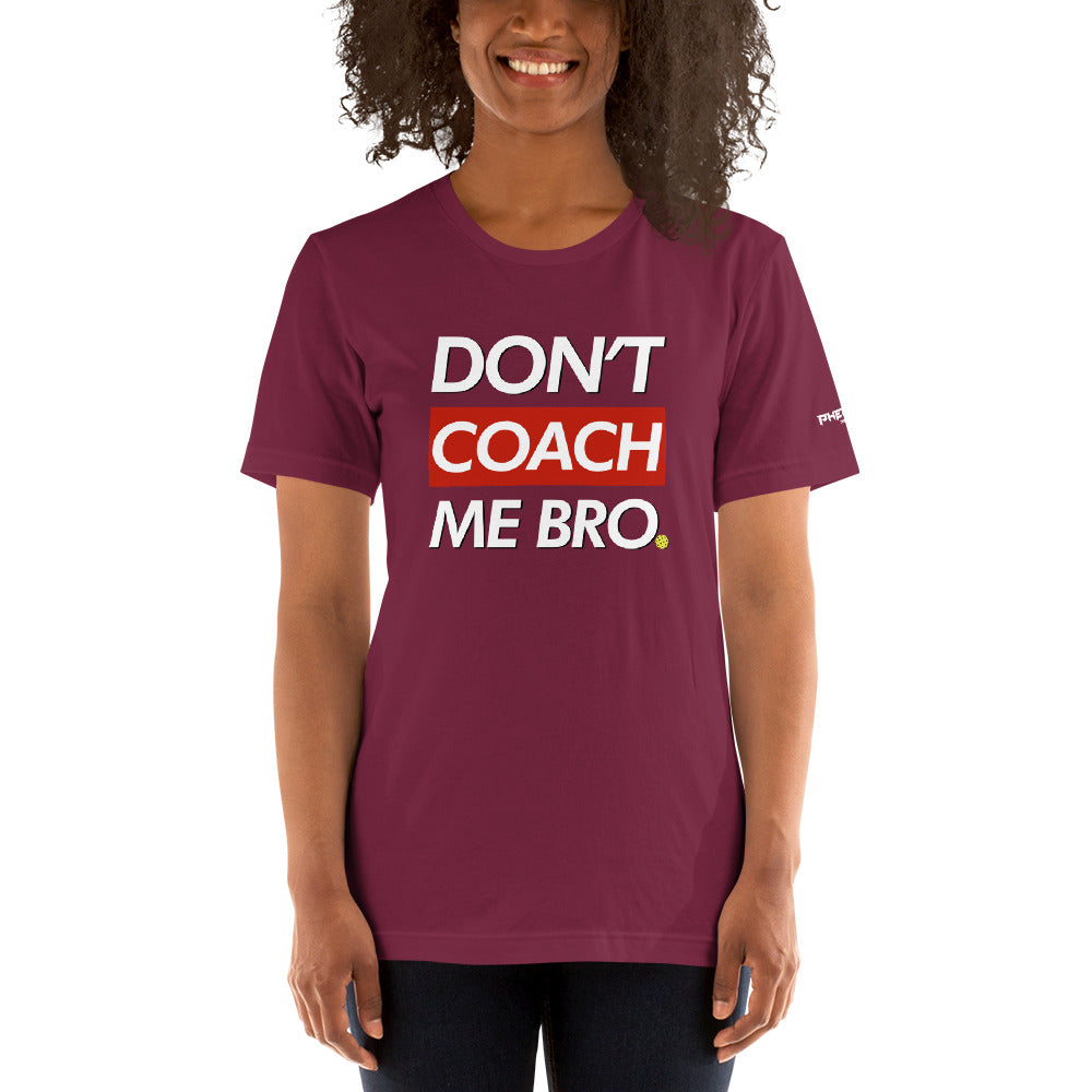 smiling woman with curly hair wearing maroon don't coach me bro pickleball shirt apparel front view