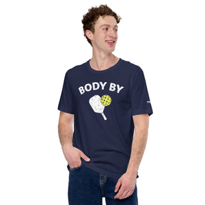 man smiling wearing navy blue body by pickleball shirt apparel with paddle and ball weathered look front view