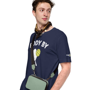 man wearing navy blue body by pickleball shirt apparel with paddle and ball weathered look phenom logo left side view