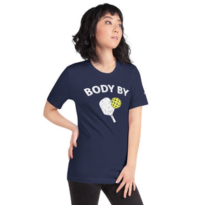 asian woman petite wearing navy blue body by pickleball shirt apparel with paddle and ball weathered look right side view