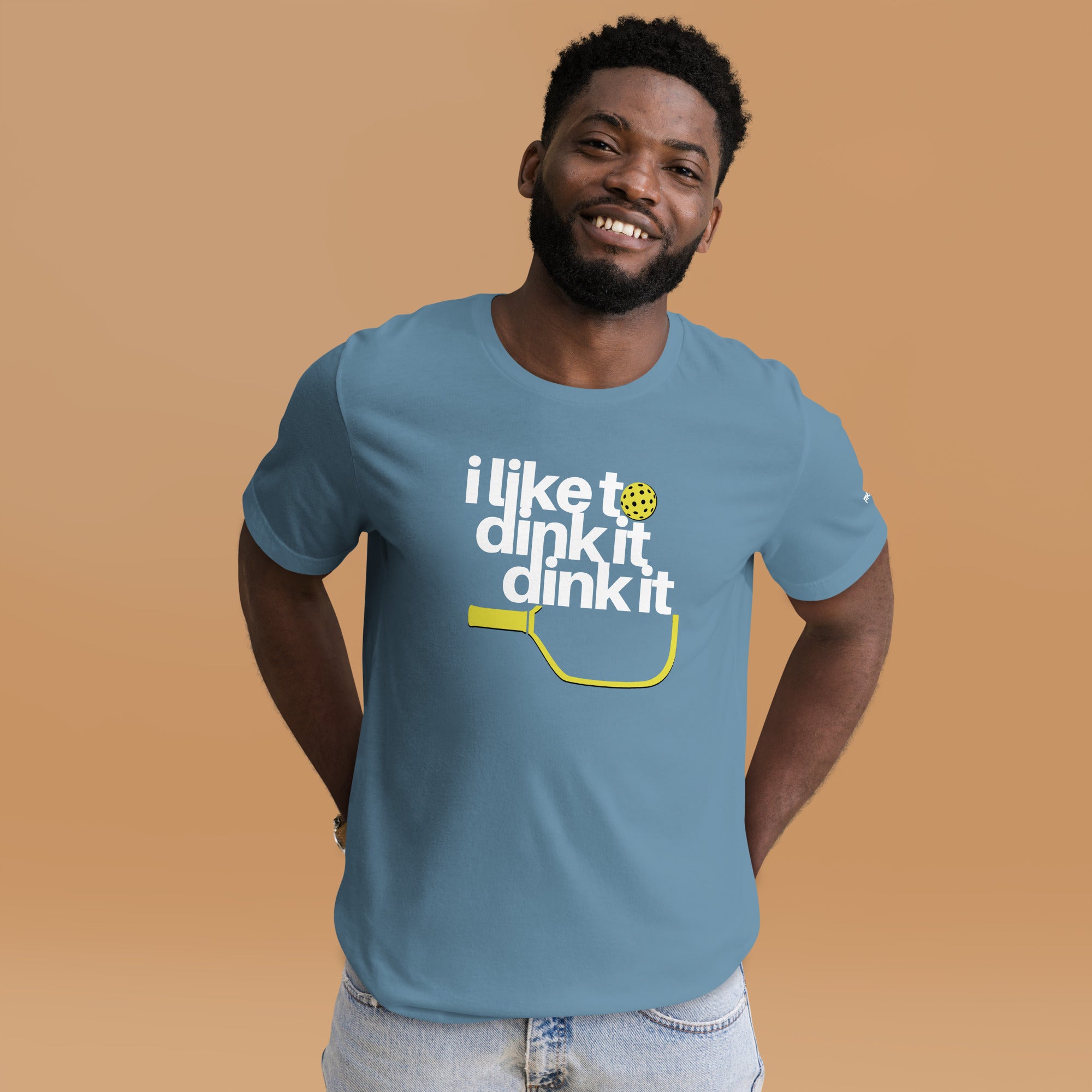 smiling man in jeans wearing steel blue i like to dink it dink it pickleball apparel athletic performance shirt front view