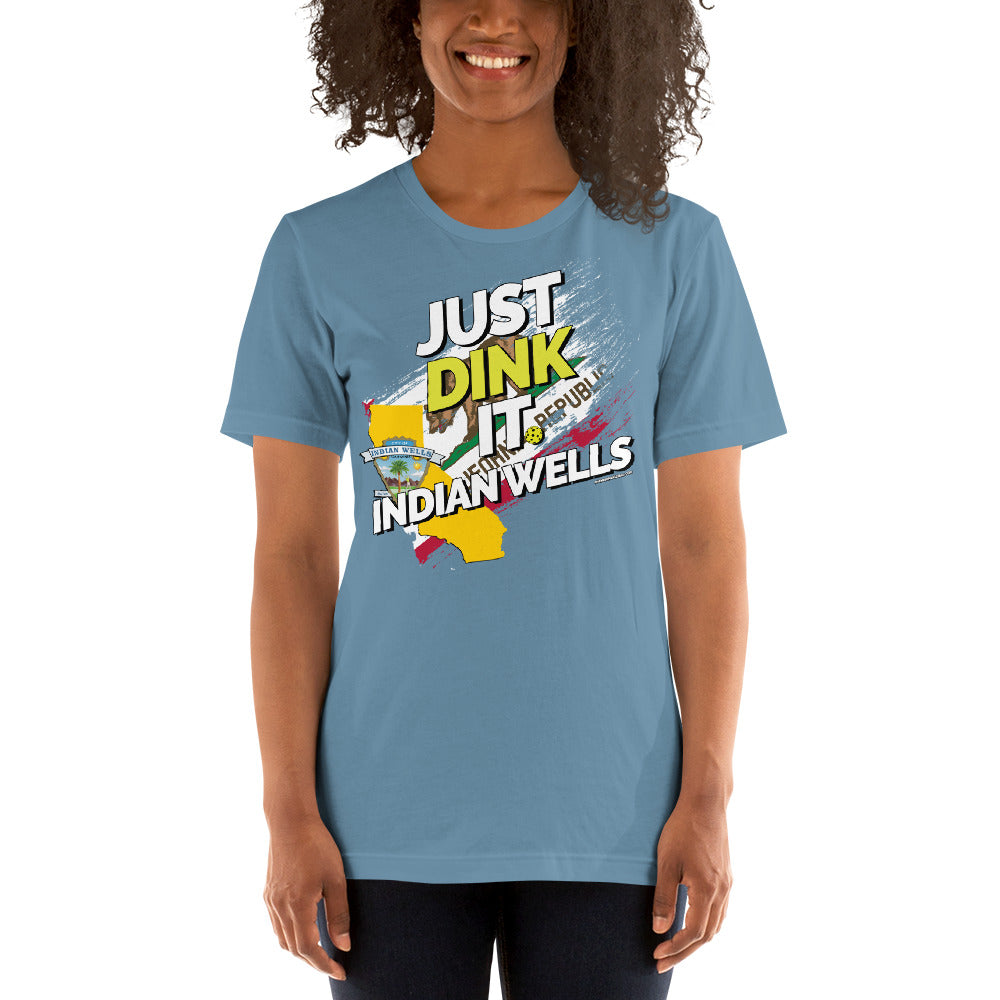 smiling woman wearing steel blue just dink it indian wells pickleball shirt performance apparel athletic top front view