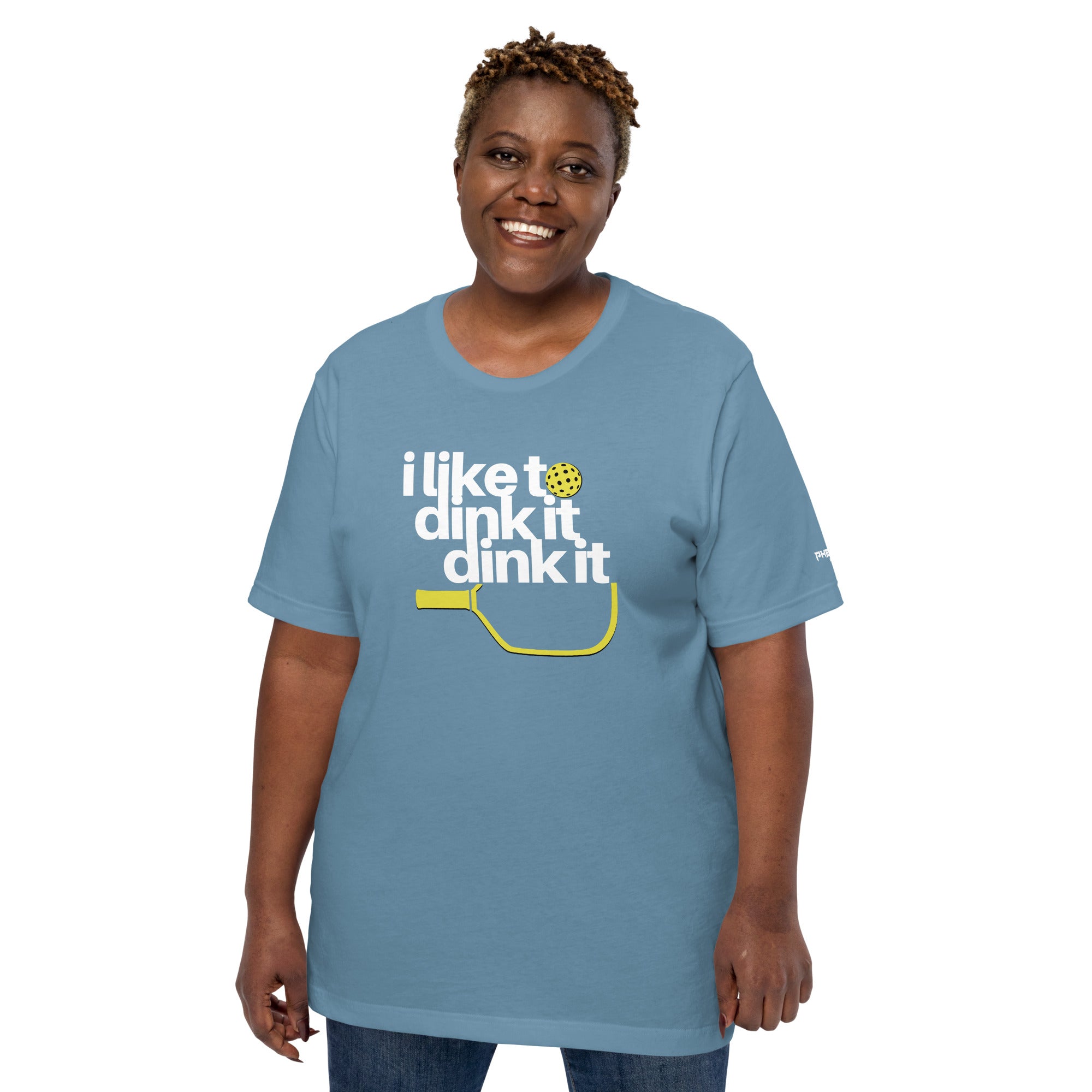 smiling plus sized woman wearing steel blue i like to dink it dink it pickleball apparel athletic performance shirt front view