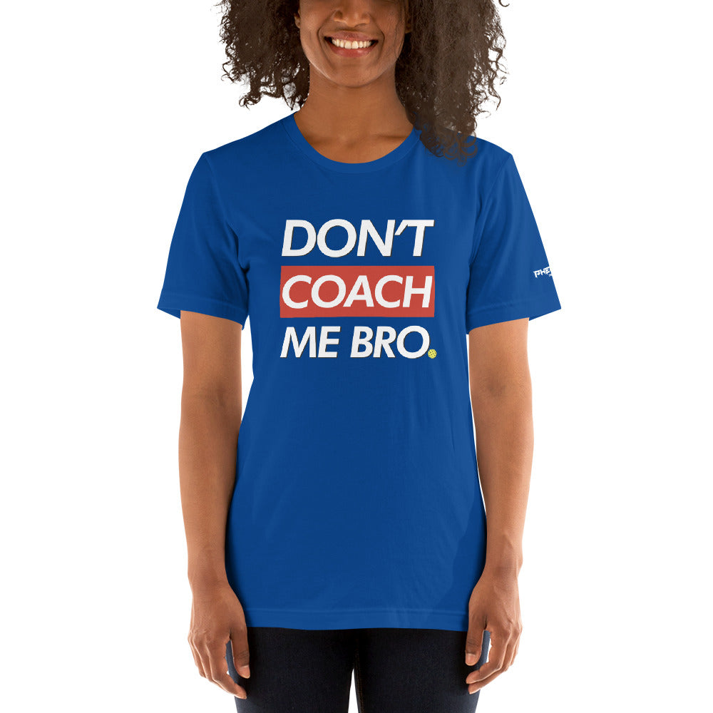 smiling woman with curly hair wearing royal blue don't coach me bro pickleball shirt apparel front view