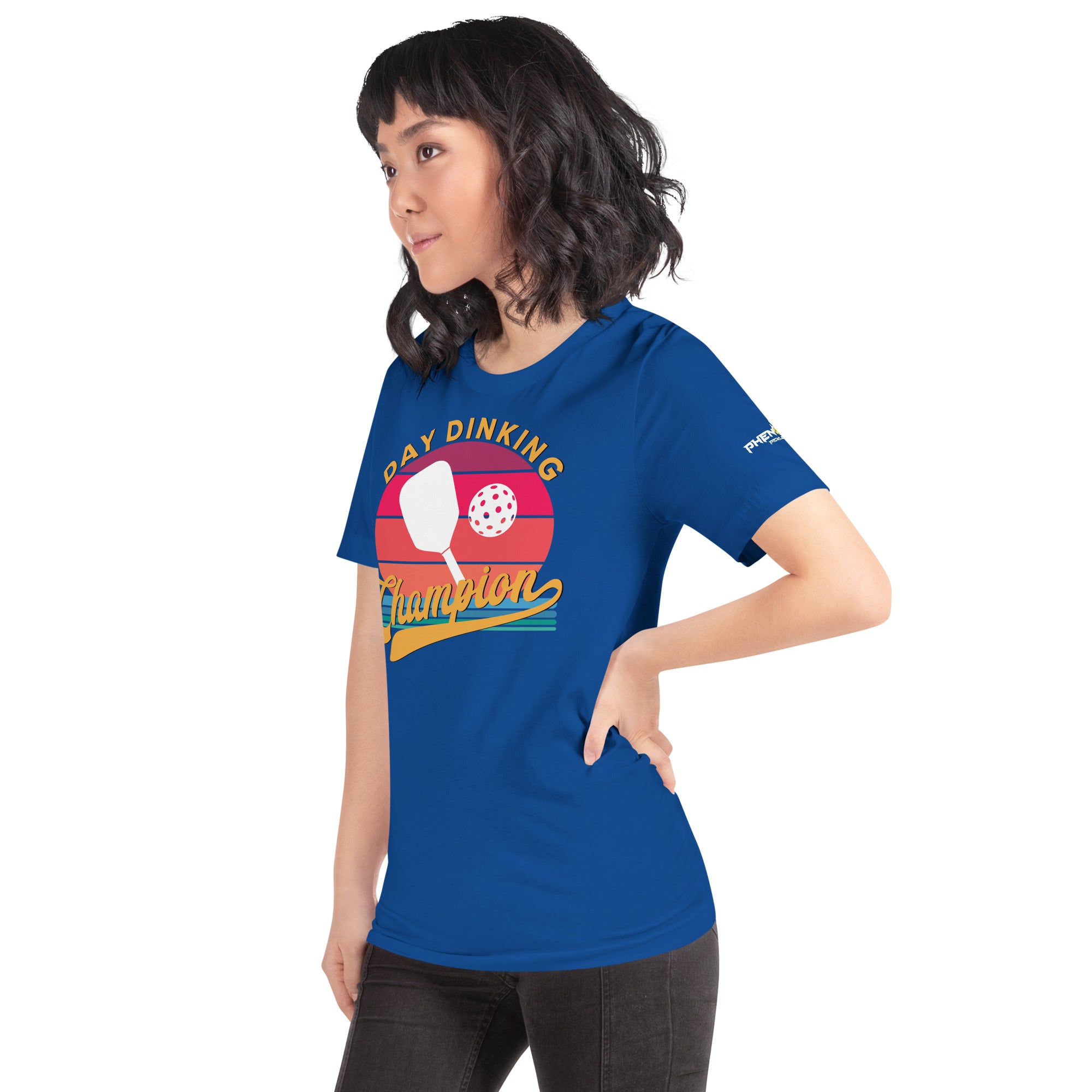 smiling asian woman wearing royal blue day dinking champion retro inspired pickleball shirt apparel phenom logo left side view