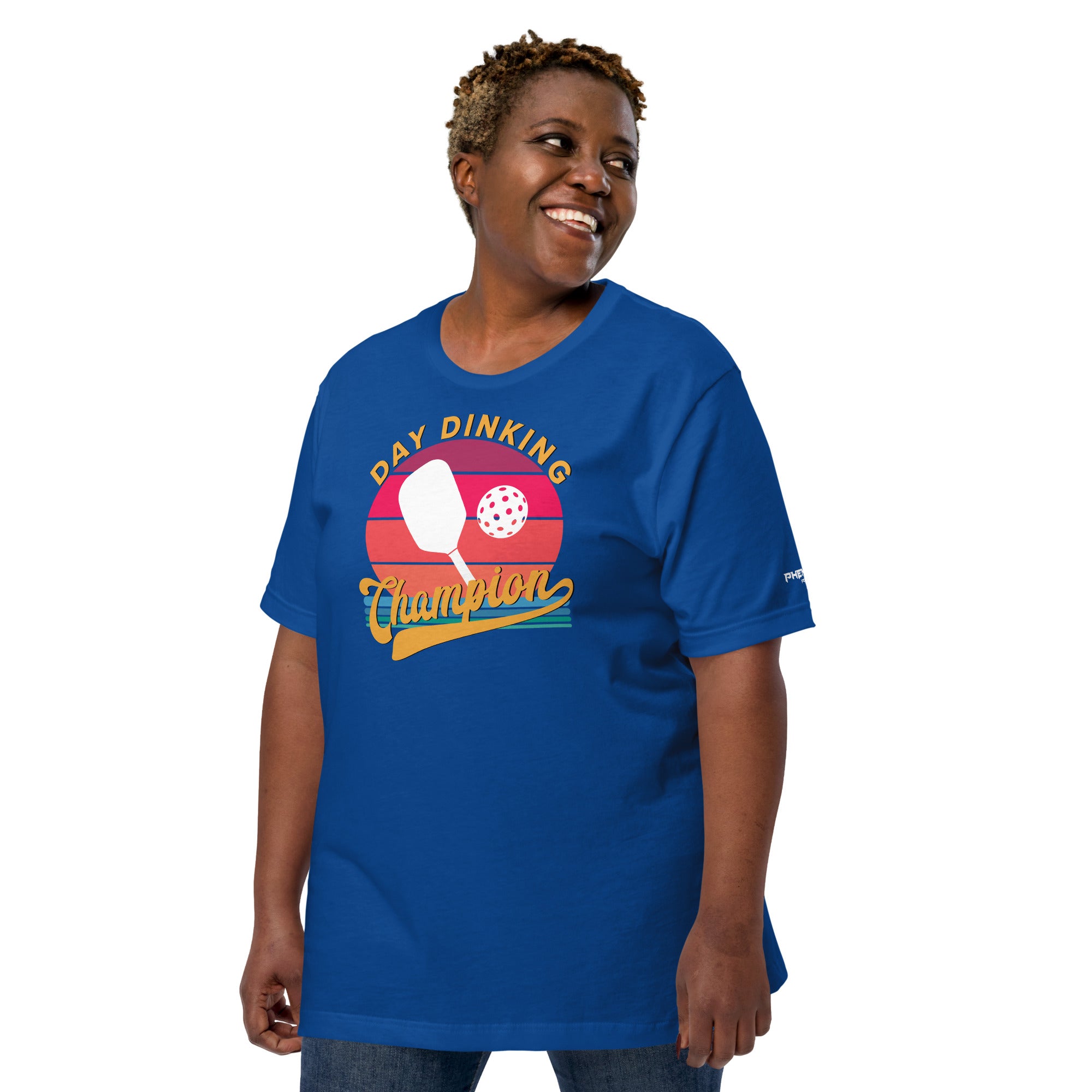 smiling plus sized woman wearing royal blue day dinking champion retro inspired pickleball shirt apparel left side view