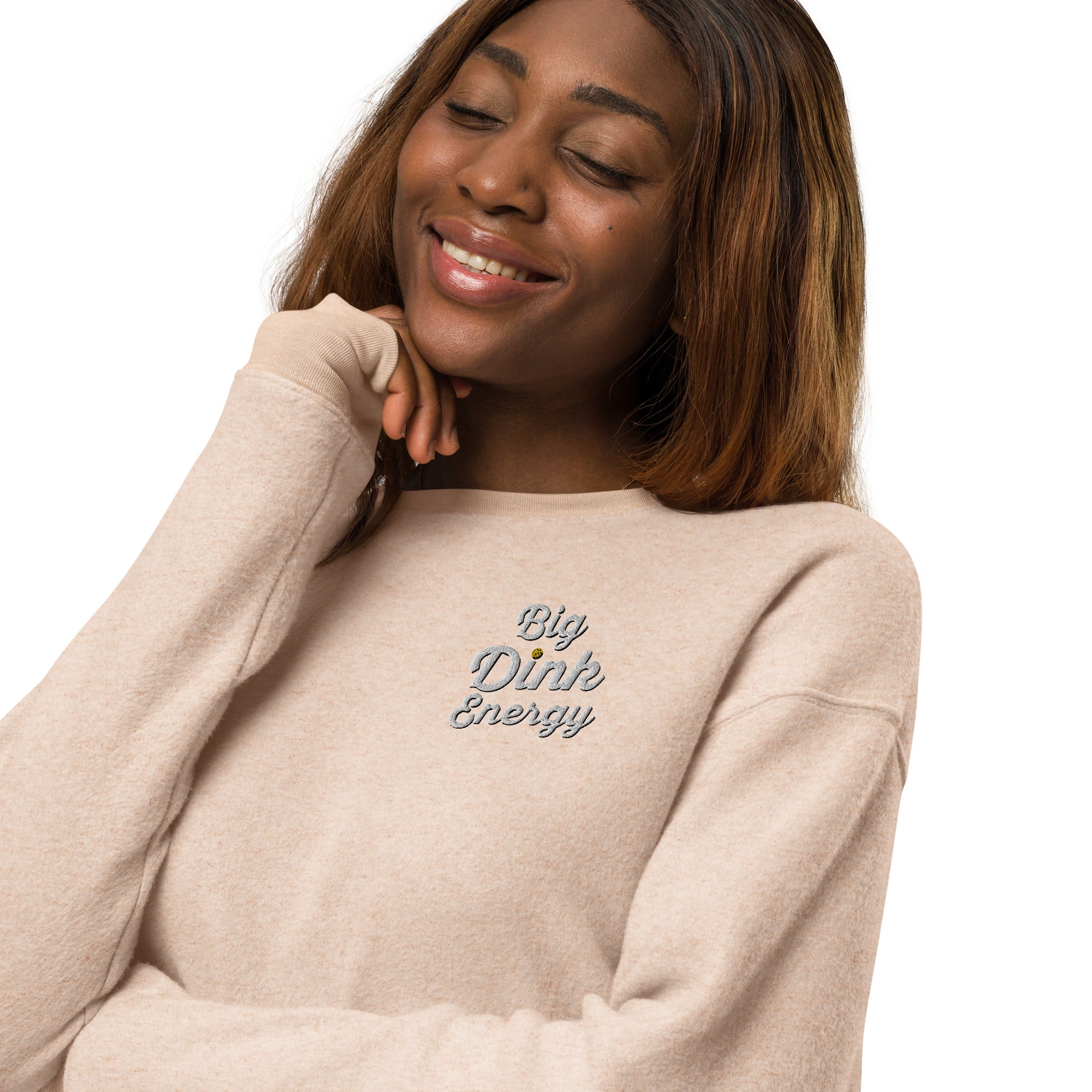 close up of smiling woman wearing light peach fleece embroidered big dink energy pickleball sweater apparel